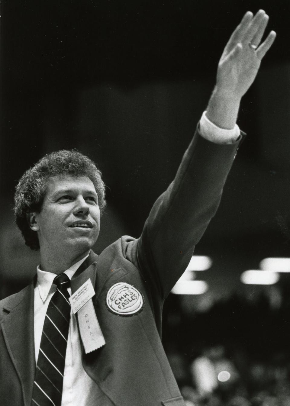 Former Central-Hower boys basketball coach Mike Meneer waves to the crowd after the team captured the Class AAA state championship in 1986.