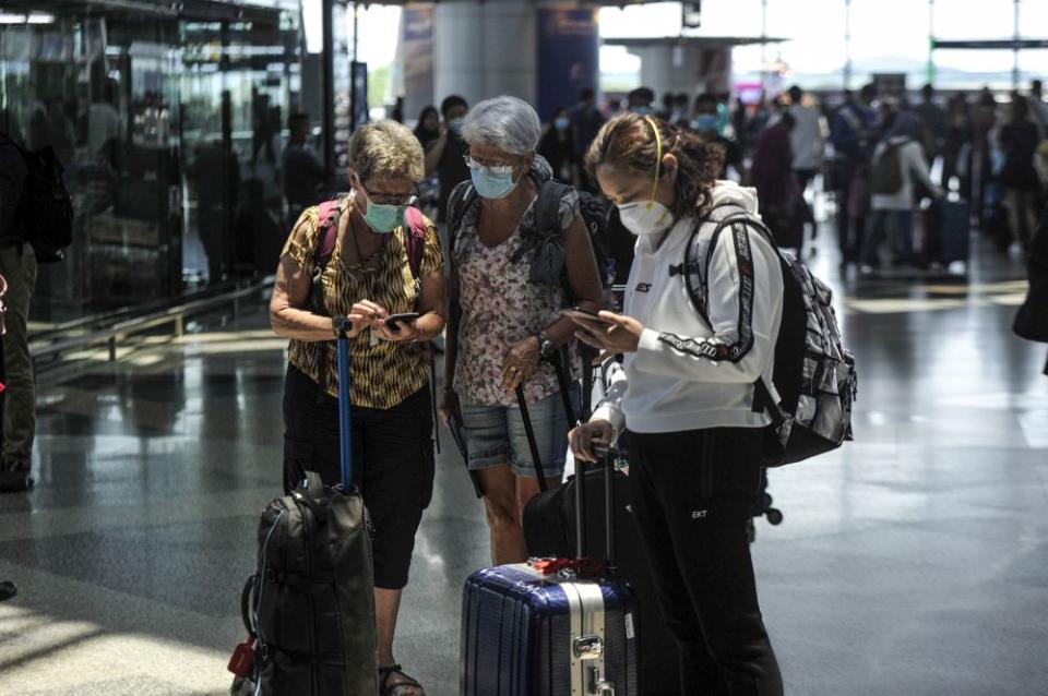 Travellers are pictured at the Kuala Lumpur International Airport in Sepang March 17, 2020. — Picture by Shafwan Zaidon