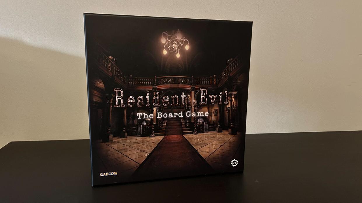  Resident Evil: The Board Game box on a black table with a white background. 