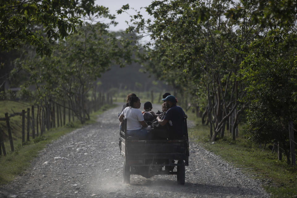 Migrants are driven to Las Tecas, the first base camp from where they will start walking across the Darien gap from Colombia to Panama in hopes of reaching the US, in Acandi, Colombia, Monday, May 8, 2023. (AP Photo/Ivan Valencia)