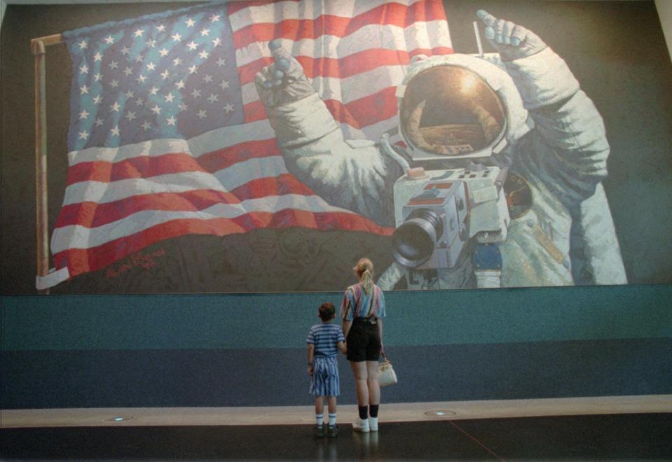 Space Center Houston visitor Lisa Marek and her son Marshall, 5, of New Ulm, Texas, study the Alan Bean mural Friday, July 15, 1994, in Houston, that depicts Neil Armstrong during the Apollo 11 mission to the moon.