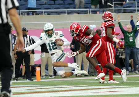 Dec 15, 2018; Orlando, FL, USA;Tulane Green Wave quarterback Justin McMillan (12) runs the ball in for a touchdown against the Louisiana-Lafayette Ragin Cajuns during the second half at Camping World Stadium. Mandatory Credit: Kim Klement-USA TODAY Sports