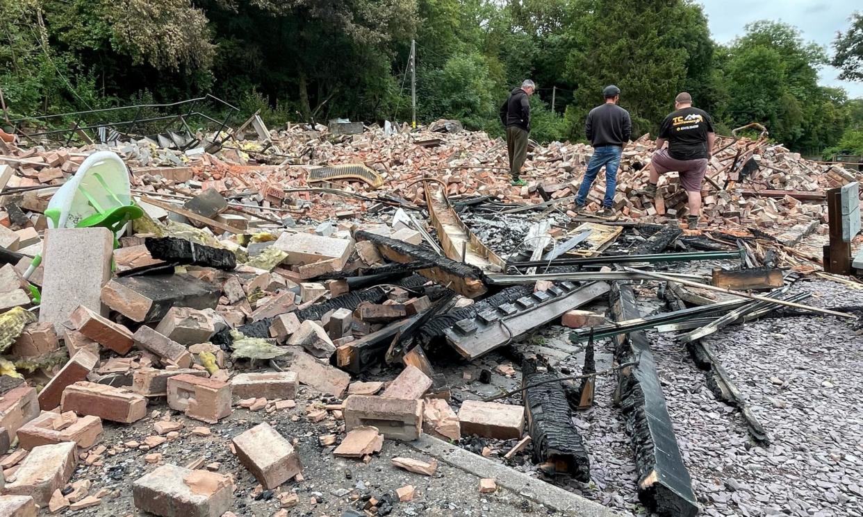 <span>People inspect the remains of the Crooked House pub in Himley, which was demolished two days after it was gutted by fire. </span><span>Photograph: Matthew Cooper/PA</span>