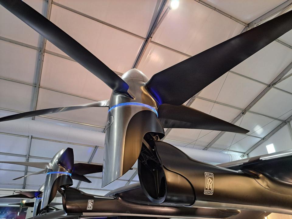 A black propellor faces upwards. It has the logo for the engineering firm Rolls-Royce