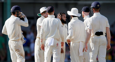 Cricket - England v Sri Lanka, Third Test - Colombo, Sri Lanka - November 24, 2018. England's Adil Rashid celebrates with his teammates after taking the wicket of Sri Lanka's Dimuth Karunaratne (not pictured). REUTERS/Dinuka Liyanawatte