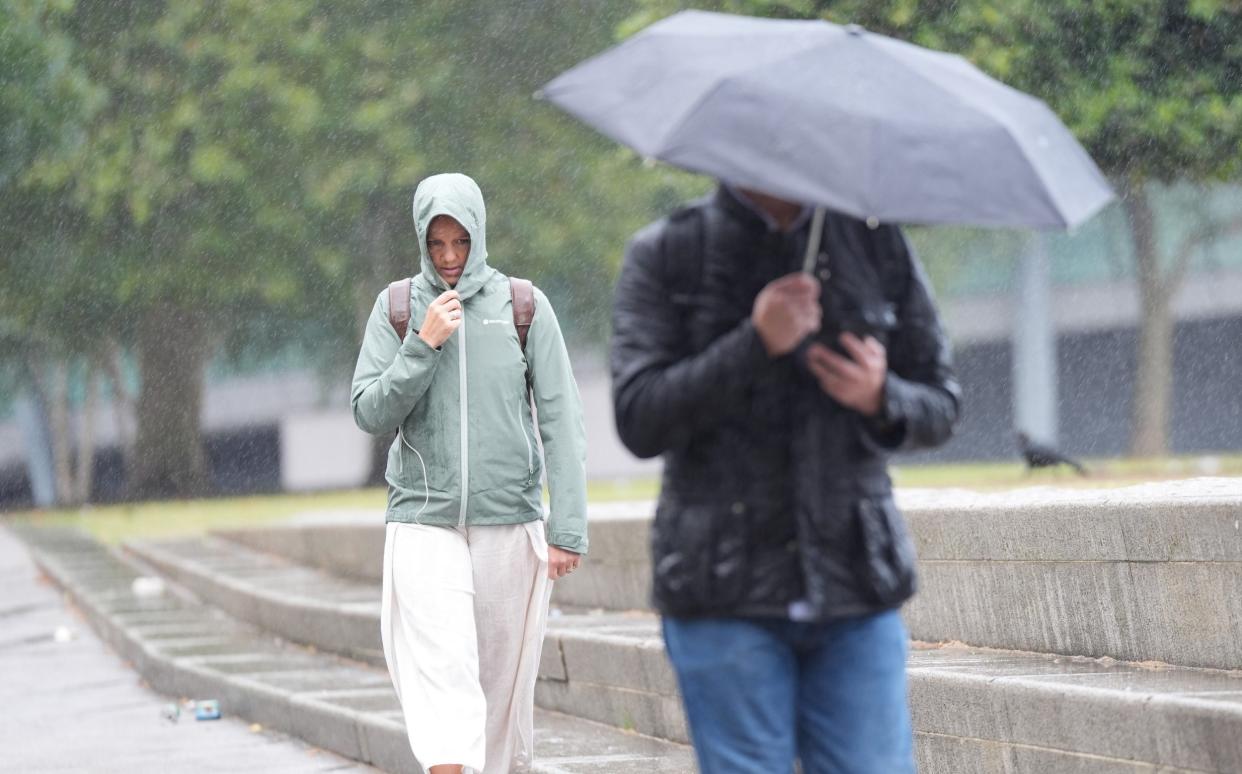 People in rain - UK experienced coolest summer in nearly a decade