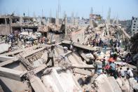 In this photograph taken on April 24, 2013, Bangladeshi civilian volunteers assist in rescue operations at the Rana Plaza complez