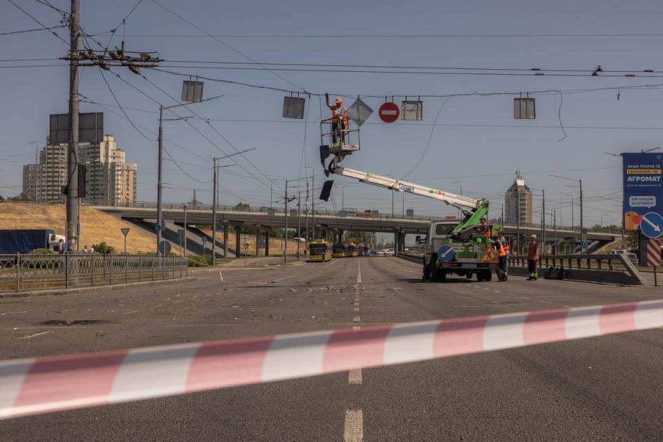 Workers at a site where debris fell during Monday’s Russian attack (Getty Images)