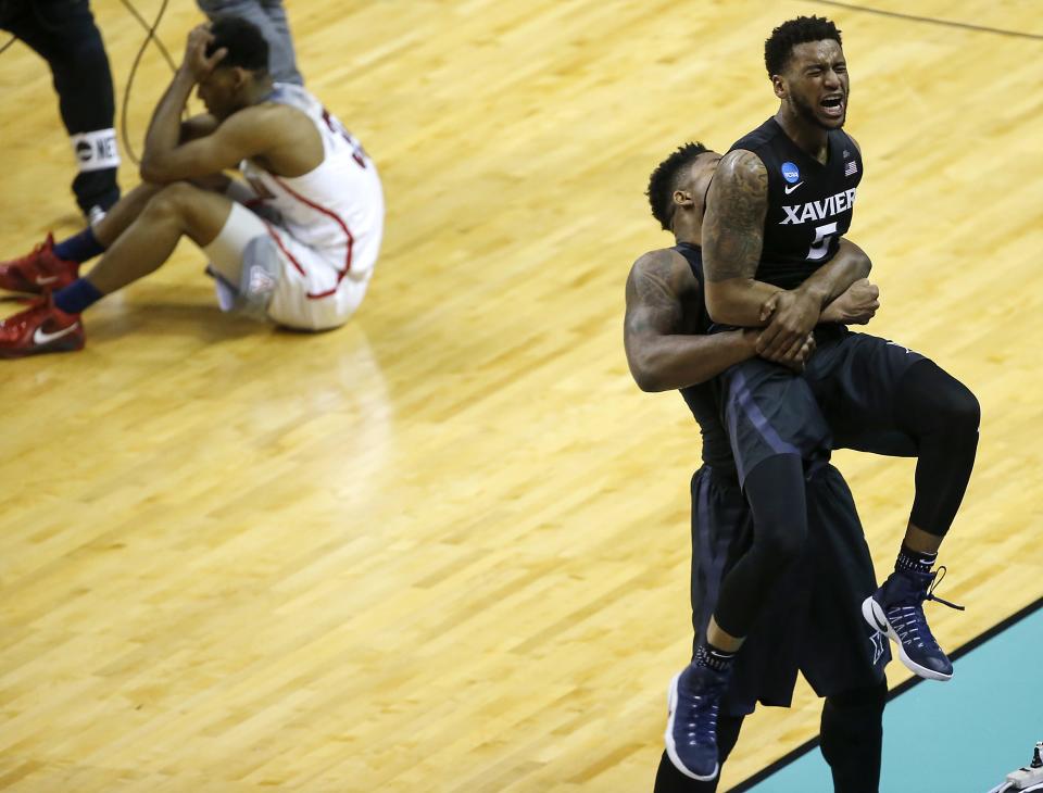 Xavier Musketeers forward Tyrique Jones (0) lifts Xavier Musketeers guard Trevon Bluiett (5) after the 73-71 win over Arizona in the round of 16 game of the men's NCAA college basketball tournament between the Xavier Musketeers and the Arizona Wildcats, Thursday, March 23, 2017, at the SAP Center in San Jose, California. Xavier won 73-71.