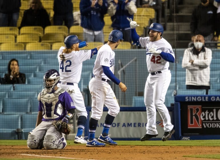 LOS ANGELES, CA - APRIL 15, 2021: Los Angeles Dodgers second baseman Max Muncy, right reacts with Los Angeles Dodgers.