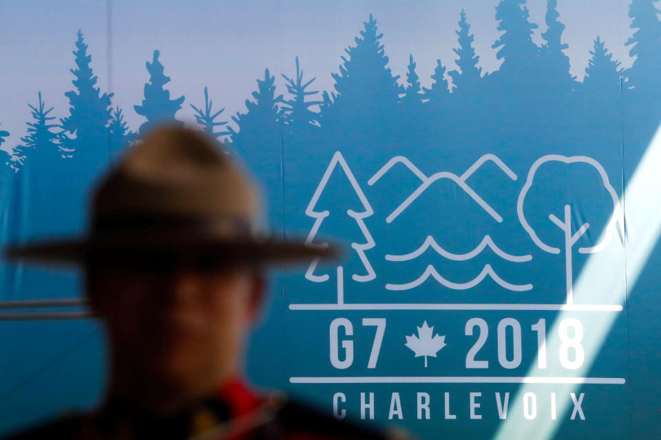 A Canadian mounted police officer stands next to the logo ahead of the G-7 summit in Quebec, Canada, June 6, 2018. (Photo: Yves Herman/Reuters)