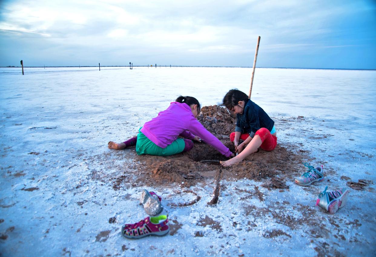 A family digs for crystals at the Salt Plains National Wildlife Refuge.