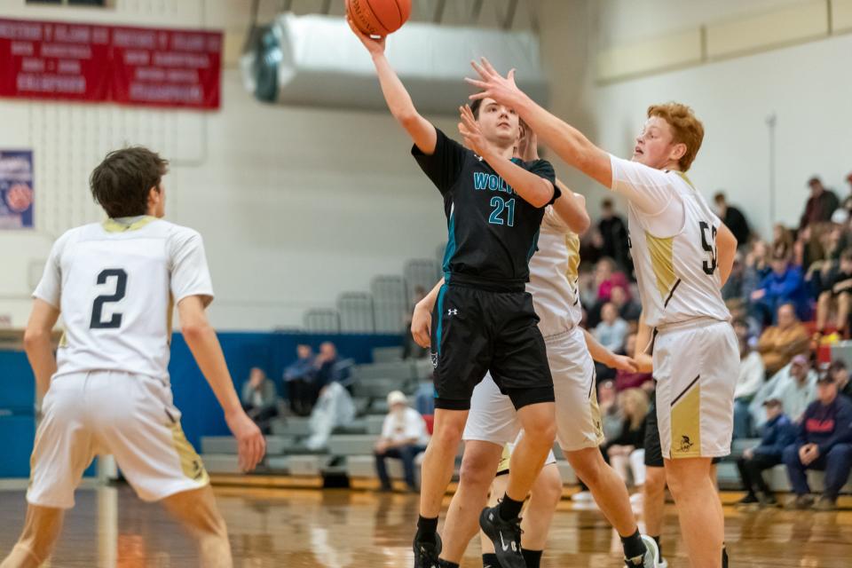 Arkport-Canaseraga's Alex Vilkhu (21) puts up a shot over the Avoca-Prattsburgh defense in Saturday night's Steuben County semifinal matchup. The Titans earned the win for a spot in the finals.