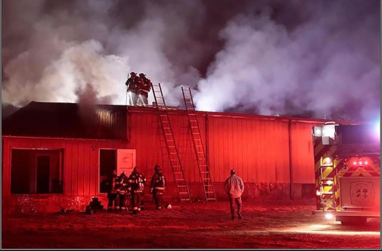 Fire crews work to put out a fire on the night of Dec. 26 at The Twisted Apple in Edneyville.