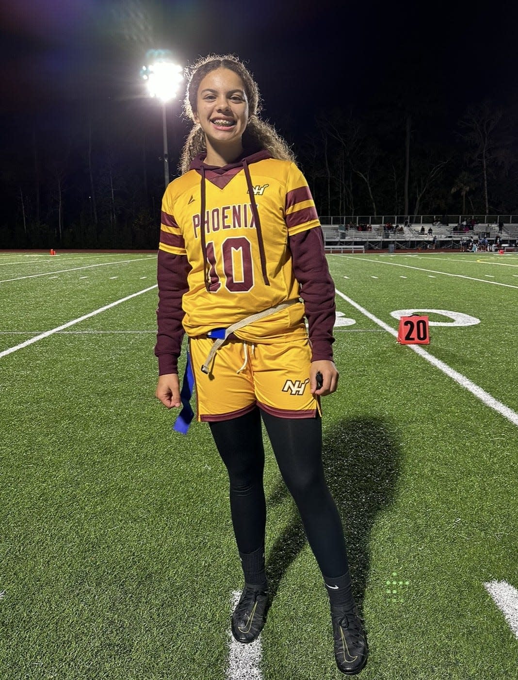 Gianna Brown of the New Hampstead flag football team poses after a 2024 win.