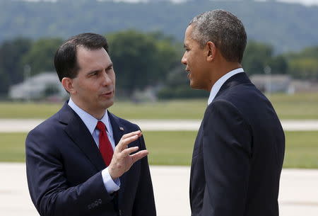 U.S. President Barack Obama is greeted by Wisconsin Governor Scott Walker upon his arrival in La Crosse, Wisconsin July 2, 2015. REUTERS/Kevin Lamarque