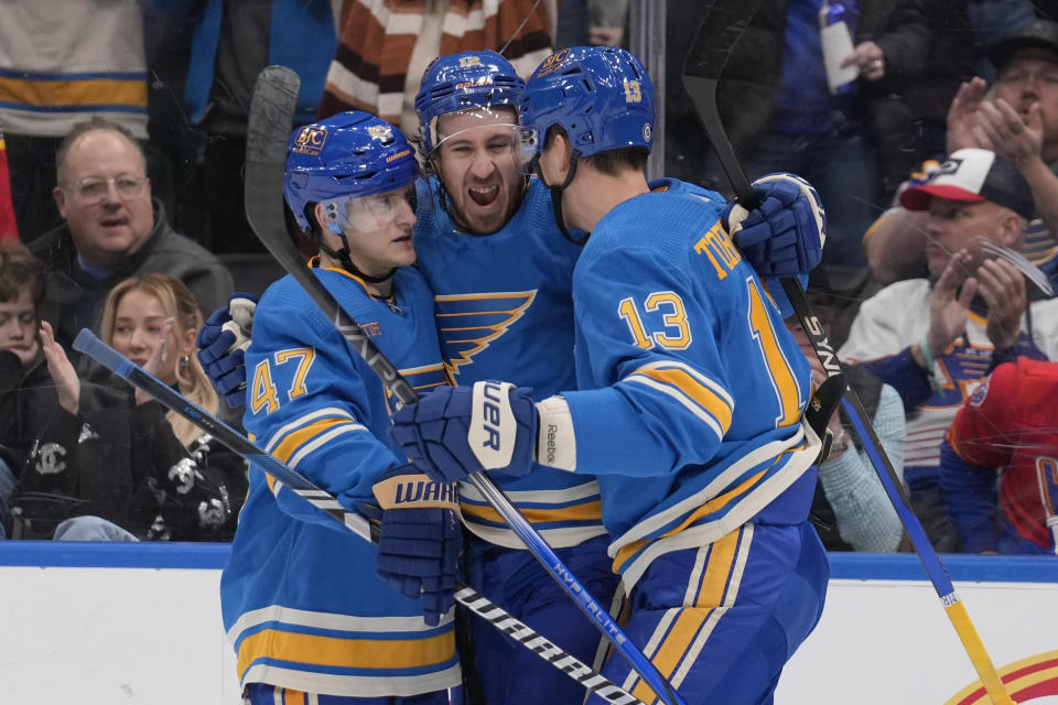 St. Louis Blues' Kevin Hayes, center, is congratulated by teammates Torey Krug (47) and Alexey Toropchenko (13) after scoring during the second period of an NHL hockey game against the Dallas Stars Saturday, Dec. 16, 2023, in St. Louis. (AP Photo/Jeff Roberson)