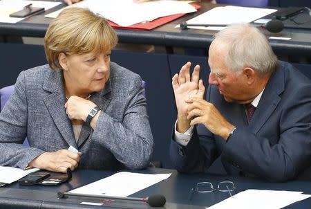 German Chancellor Angela Merkel talks with Finance Minister Wolfgang Schaeuble prior to a vote on Greece's third bailout programme during a session of Germany's parliament, the Bundestag, in Berlin, Germany, August 19, 2015. REUTERS/Axel Schmidt