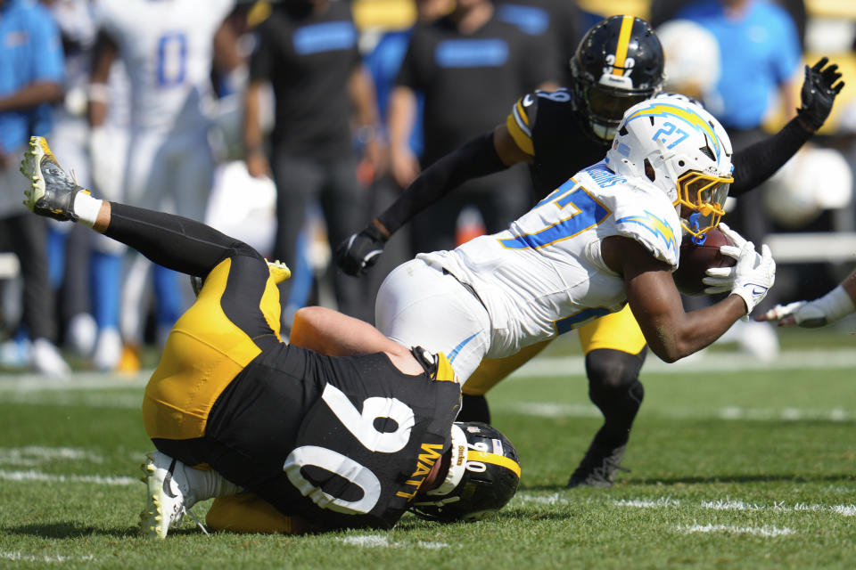 Los Angeles Chargers running back J.K. Dobbins (27) is tackled by Pittsburgh Steelers linebacker T.J. Watt (90) during the second half of an NFL football game, Sunday, Sept. 22, 2024, in Pittsburgh. (AP Photo/Gene J. Puskar)