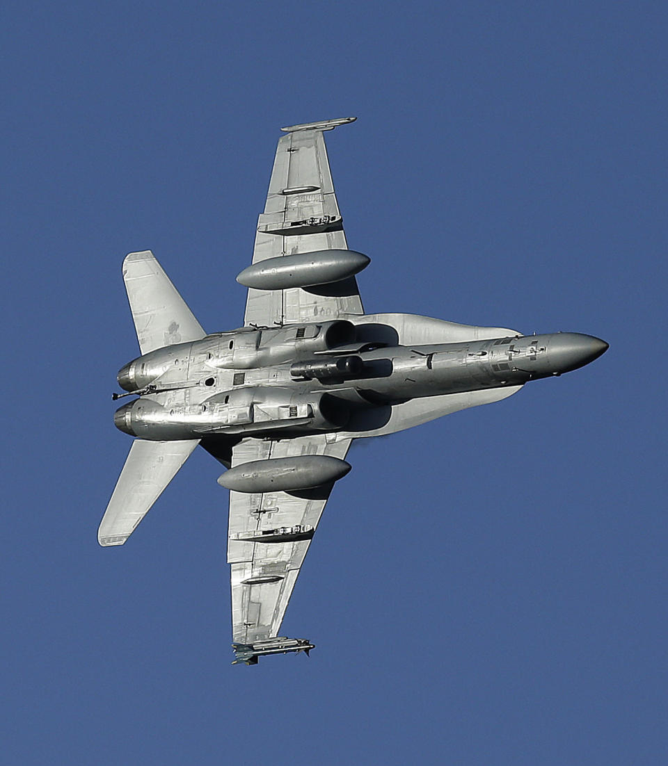 In this Feb. 27, 2017, photo, an F/A-18D Hornet with the VX-9 Vampire squadron from Naval Air Weapons Station, China Lake, banks over the nicknamed Star Wars Canyon in Death Valley National Park, Calif. Military jets roaring over national parks have long drawn complaints from hikers and campers. But in California's Death Valley, the low-flying combat aircraft skillfully zipping between the craggy landscape has become a popular attraction in the 3.3 million acre park in the Mojave Desert, 260 miles east of Los Angeles. (AP Photo/Ben Margot)