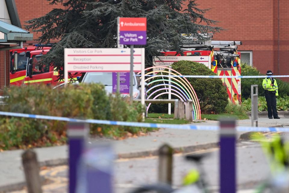 A police officer stands behind a cordoned-off area outside the Women's Hospital in Liverpool on November 15, 2021 following a car blast. - British police announced the arrest of three men after a car exploded in front of Liverpool Women's Hospital in the city centre, killing one man and injuring another. (Photo by Paul ELLIS / AFP) (Photo by PAUL ELLIS/AFP via Getty Images)
