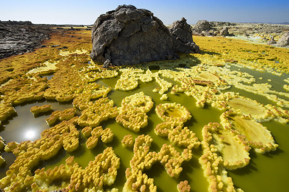 <p>The extraordinary snaps were taken in Ethiopia and show vibrant yellow and green craters stretching for miles around. (Photo: Francesco Pandolfo/Caters News) </p>