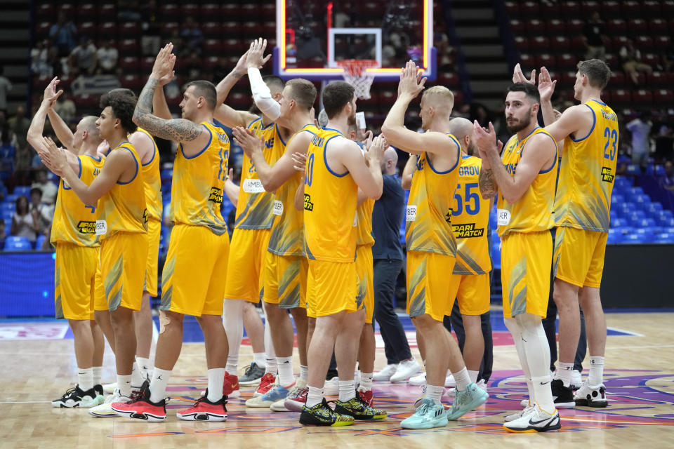 Ukraine's players celebrate at the end of the Eurobasket group C basketball match between Ukraine and Britain at the Assago Forum, near Milan, Italy Friday Sept. 2, 2022. Ukraine beat Britain 90-61.(AP Photo/Luca Bruno)