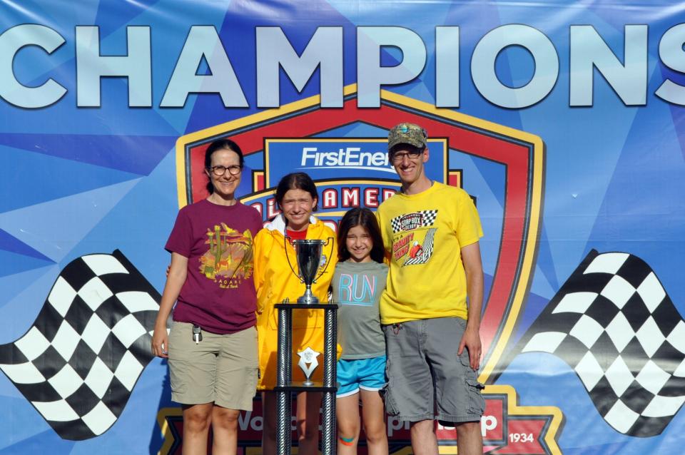 Eleni Fischer (in yellow jacket) poses with her family after winning the All-American Soap Box Derby superstock division on July 23.