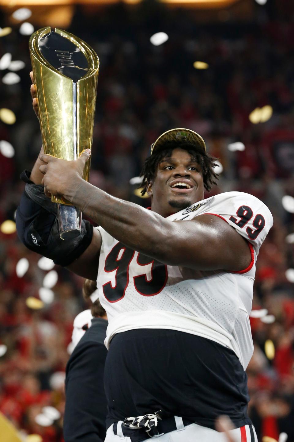 Georgia defensive lineman Jordan Davis raises the National Championship trophy.