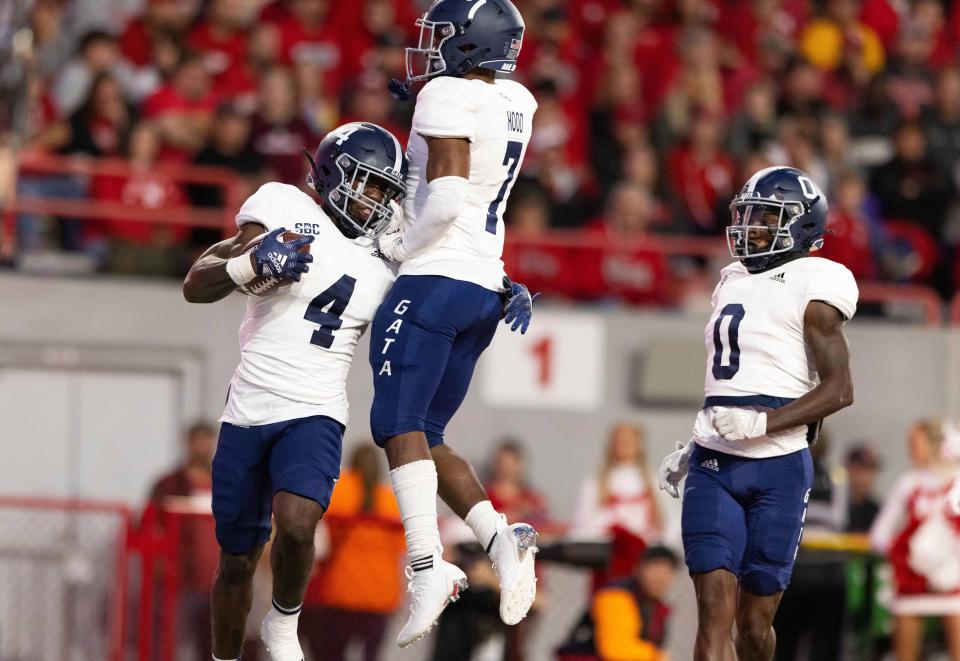 Georgia Southern's Gerald Green (4) celebrates with Khaleb Hood (7) and Sam Kenerson (0) after rushing 47 yards for a touchdown against Nebraska during the first half on Saturday, Sept. 10, 2022, in Lincoln, Nebraska.