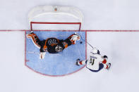 Florida Panthers' Jonathan Huberdeau, right, scores a goal against Philadelphia Flyers' Carter Hart during the third period of an NHL hockey game, Saturday, Oct. 23, 2021, in Philadelphia. (AP Photo/Matt Slocum)