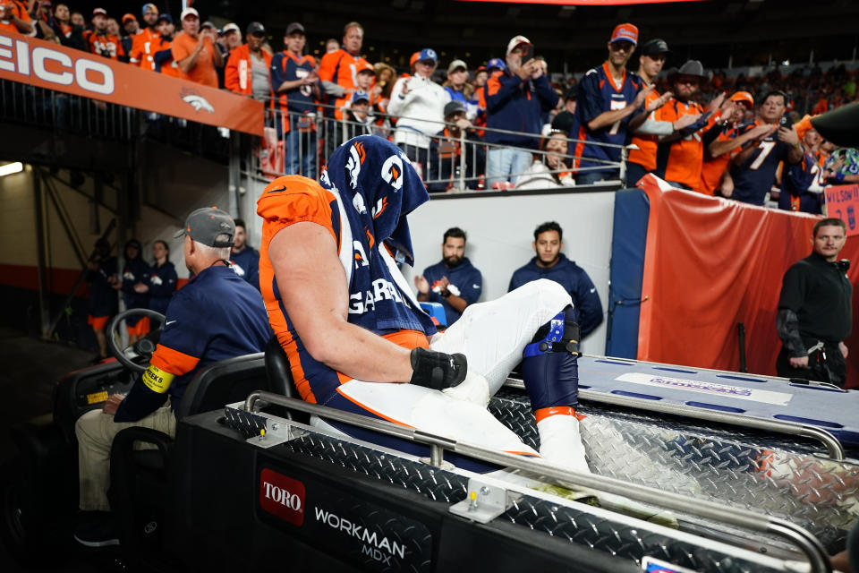 Denver Broncos offensive tackle Garett Bolles is carted off the field after an injury against the Indianapolis Colts during the second half of an NFL football game, Thursday, Oct. 6, 2022, in Denver. (AP Photo/Jack Dempsey)