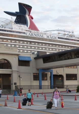 Passengers disembark from the Carnival Magic cruise ship after it reached port in Galveston, Texas October 19, 2014. REUTERS/Daniel Kramer