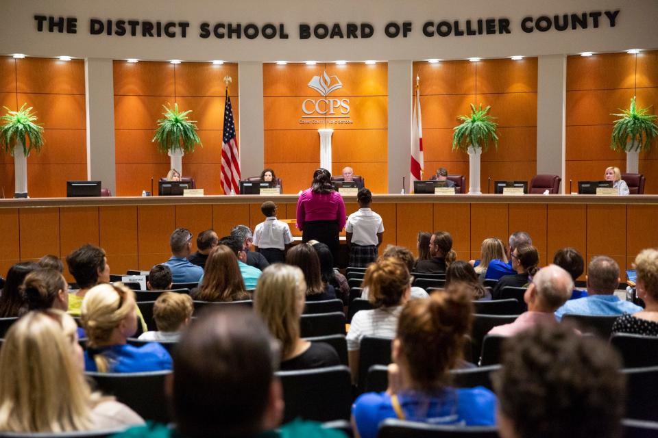In this file photo, Pearline Foster, center, stands with her children, Othniel, 9, left, and Rebekah, 12, right, both students at Mason Classical Academy, as she speaks in support of the school during a special School Board meeting at the Collier County School District office in Naples on Thursday, July 11, 2019.