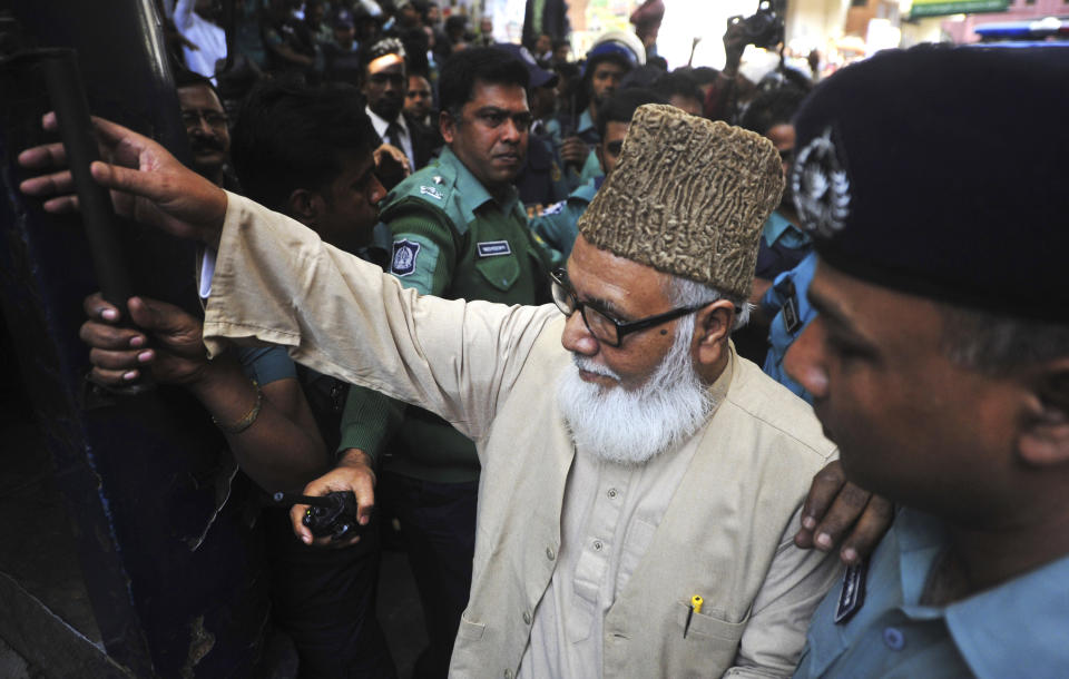 Matiur Rahman Nizami, head of the country's main Islamist opposition party Jamaat-e-Islami, enters a prison van at a court in Chittagong, Bangladesh, Thursday, Jan. 30, 2014. Nizami was among 14 people sentenced to death on Thursday on charges of smuggling weapons to a rebel group in neighboring India. (AP Photo/Khurshed Rinku)