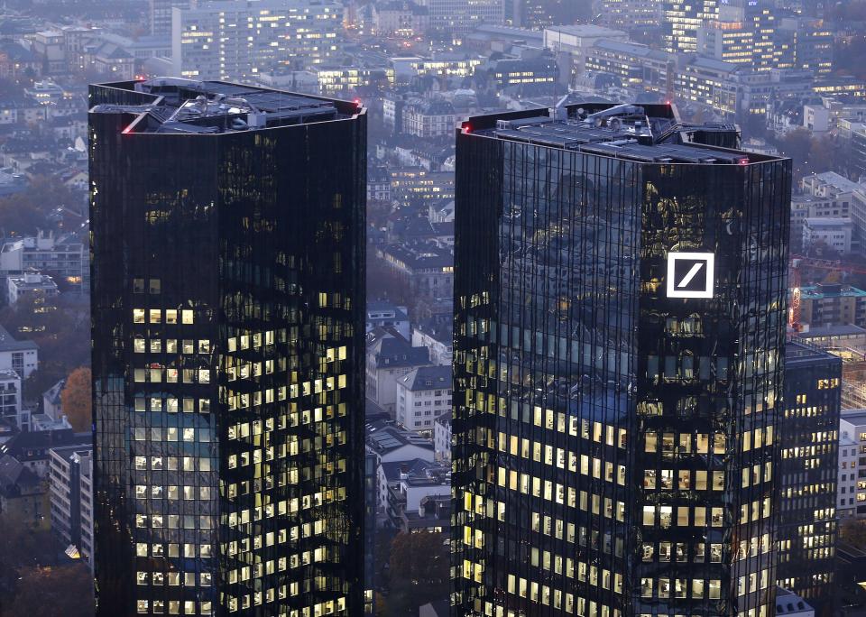 FILE - In this Nov. 13, 2012 file photo the headquarters of Deutsche Bank is photographed in Frankfurt, Germany. Shares of Deutsche Bank AG have fallen sharply after Germany's biggest lender announced a large fourth-quarter net loss, its results weighed down by one-time expenses and losses on investments it is disposing of to strengthen its finances. The bank on Sunday night, Jan. 19, 2014 posted a fourth-quarter net loss of 965 million euros (US dollar 1.3 billion), an announcement that came 10 days before it was scheduled to release its results. (AP Photo/Michael Probst, File)