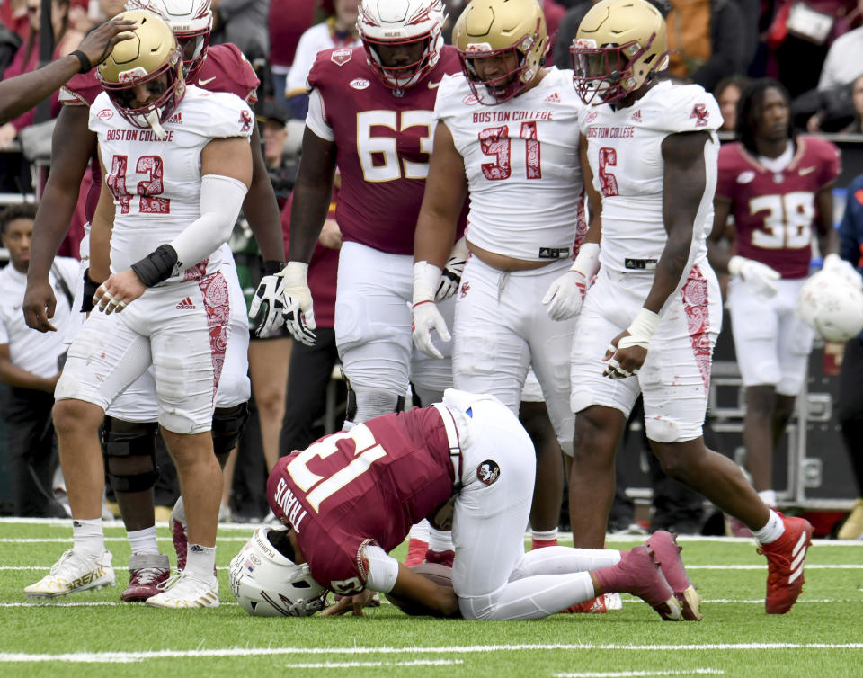 Florida State quarterback Jordan Travis (13) stays on the ground after a tackle that injured his shoulder during the first half of an NCAA college football game, Saturday, Sept. 16, 2023 in Boston. (AP Photo/Mark Stockwell)