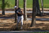 Ian Poulter, of England, hits out of the trees on the fifth hole during the first round of the The Players Championship golf tournament Thursday, March 11, 2021, in Ponte Vedra Beach, Fla. (AP Photo/John Raoux)