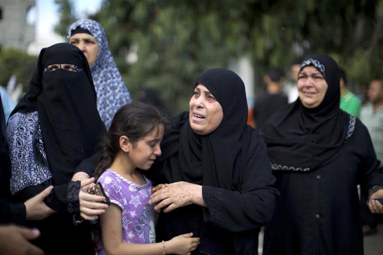 Palestinian women mourn outside the mourgue of al-Shifa hospital in Gaza City on July 31, 2014