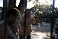 Cuban migrants take a bath as they wait for the opening of the border between Costa Rica and Nicaragua in Penas Blancas, Costa Rica November 16, 2015. More than a thousand Cuban migrants hoping to make it to the United States were stranded in the border town of Penas Blancas, Costa Rica, on Monday after Nicaragua closed its border on November 15, 2015 stoking diplomatic tensions over a growing wave of migrants making the journey north from the Caribbean island. REUTERS/Juan Carlos Ulate