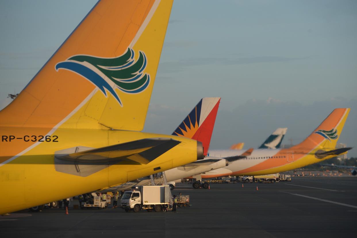 Philippine (2nd L) and Cebu Pacific (L,R) airlines planes sit at the tarmac of the Manila international airport.