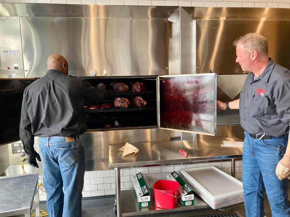 Pit master Robert Jones, left, checks the meats slow-smoked on site at the new Sonny’s BBQ at 5811 Zebulon Road in Macon. Becky Purser/The Telegraph