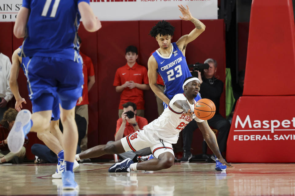 St. John's forward David Jones passes the ball as Creighton guard Trey Alexander, top, defends during the second half of an NCAA college basketball game Saturday, Feb. 18, 2023, in New York. (AP Photo/Jessie Alcheh)