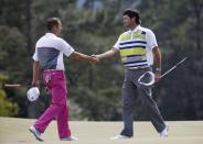 U.S. golfer Bubba Watson (R) shakes hands with playing partner Sergio Garcia of Spain after completing the second round of the Masters golf tournament at the Augusta National Golf Club in Augusta, Georgia April 11, 2014. REUTERS/Mike Segar (UNITED STATES - Tags: SPORT GOLF)