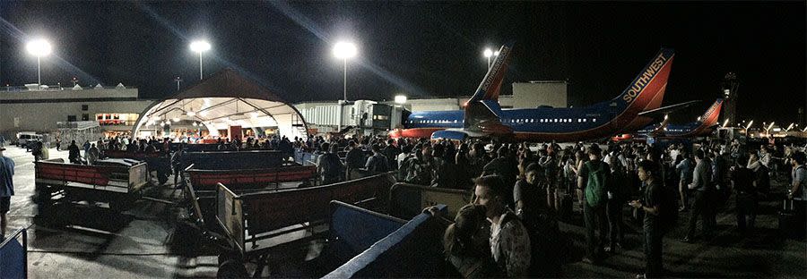 Travellers crowd around planes on the runway amid reports of active shooter. Photo: Ross Greenberg