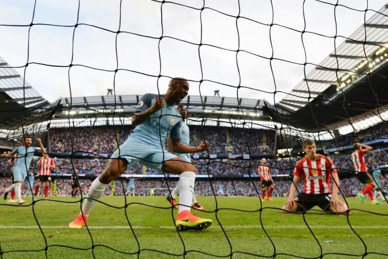 Manchester City's midfielder Fabian Delph (C) celebrates after Sunderland's defender Paddy McNair (2R) scored an own goal during the English Premier League match on August 13, 2016