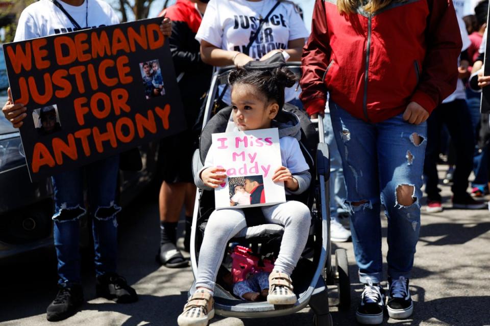 Ailani Alvarez, 2, daughter of Anthony Alvarez who was shot by the police, holds a sign reading ‘I miss my daddy’ during a 2021 protest in Chicago (Associated Press)