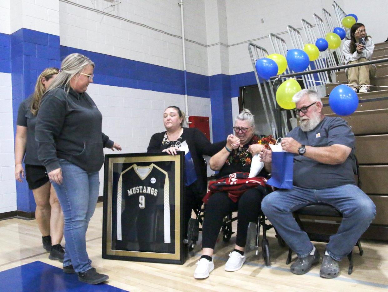 Lucerne Valley High School volleyball coaches present the retired jersey of the late-Kayden Davis,16, to her family during a Lady Mustangs’ volleyball team game on Thursday, Oct. 12, 2023.