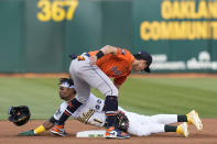 Oakland Athletics' Esteury Ruiz (1) steals second base against Houston Astros shortstop Mauricio Dubón, top, during the first inning of a baseball game in Oakland, Calif., Friday, May 26, 2023. (AP Photo/Godofredo A. Vásquez)