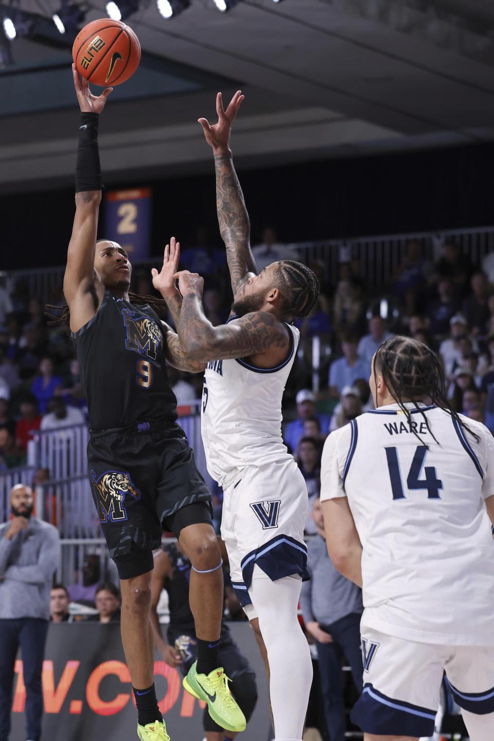 In a photo provided by Bahamas Visual Services, Villanova's Justin Moore, from second right, attempts to block Memphis' Caleb Mills during an NCAA college basketball game in the Battle 4 Atlantis at Paradise Island, Bahamas, Friday, Nov. 24, 2023. (Tim Aylen/Bahamas Visual Services via AP)